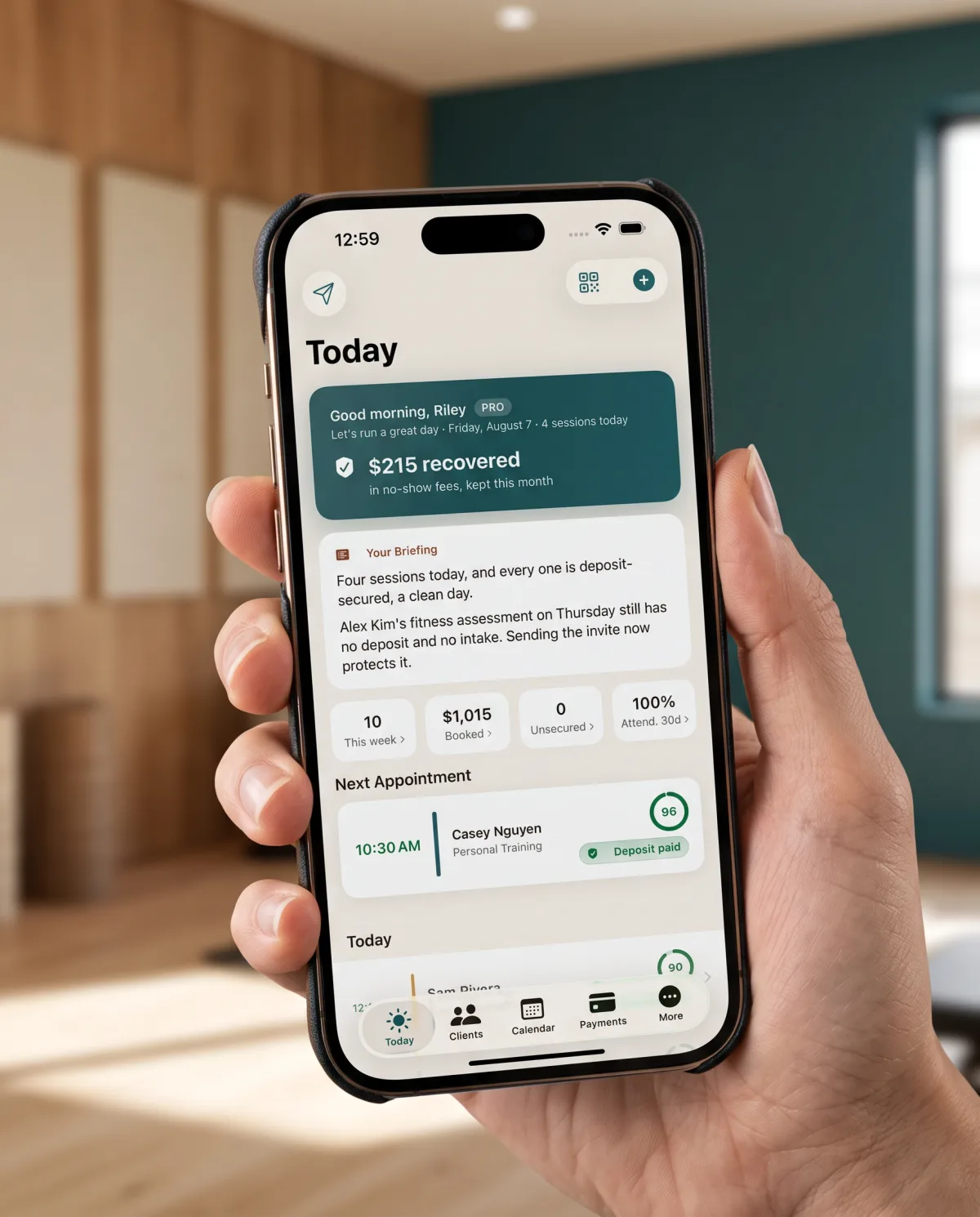 A phone showing the Today screen: $215 recovered in no-show fees this month, a written briefing, and the next appointment marked deposit paid.
